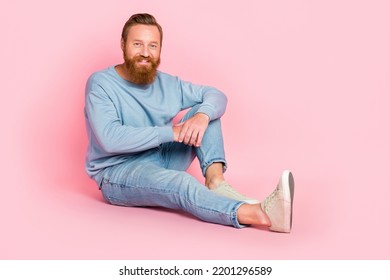 Full Body Photo Of Satisfied Friendly Person Sit Floor Toothy Smile Isolated On Pink Color Background