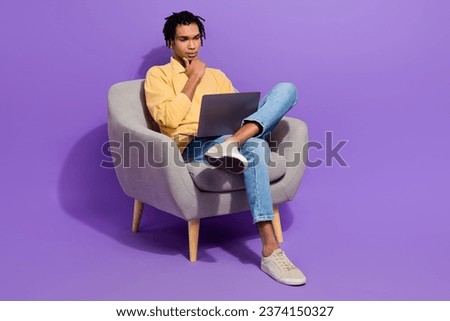 Full body photo of serious think man student touch chin decide logic rational solution work computer isolated on purple color background