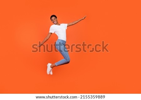Full body photo of short butch hair androgyne lady jump hands plain wings unisex look isolated bright color background
