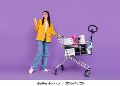 Full body photo of trendy model lady sell stuff online recycle appliance wear yellow blazer jeans isolated on violet color background