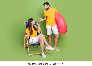 Full Body Photo Of Two Positive Cheerful People Chatting Communicate Enjoy Rest Chaise Lounge Isolated On Green Color Background