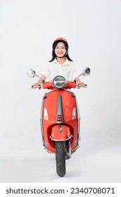 full body photo of a woman wearing a helmet and driving a motorbike
