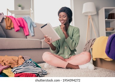 Full Body Photo Of Young Attractive Woman Happy Positive Smile Think Choose Buy Clothes Online Shopper Sit Floor Home