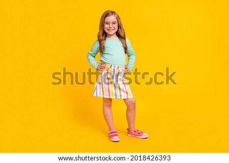 Full body photo of young attractive preteen girl happy positive smile wear casual outfit isolated over yellow color background