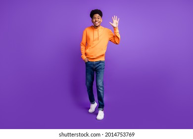 Full Body Photo Of Young Black Man Happy Positive Smile Waving Hand Hello Hi Isolated Over Violet Color Background