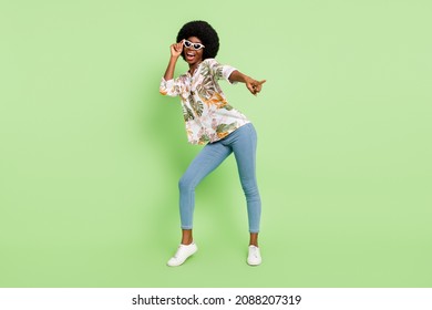 Full Body Photo Of Young Black Girl Happy Positive Smile Dance Point Finger Empty Space Isolated Over Green Color Background