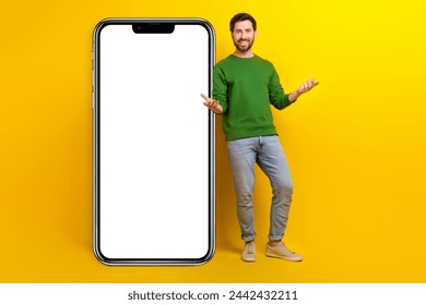 Full body photo of young businessman wear green pullover friendly invite join cyber family community isolated on yellow color background - Powered by Shutterstock