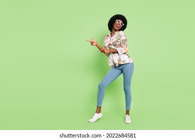 Full Body Photo Of Young Cheerful Afro Girl Happy Positive Smile Point Fingers Empty Space Dancer Isolated Over Green Color Background