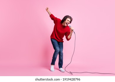 Full Body Photo Of Young Excited Man Happy Smile Enjoy Sing Song Microphone Isolated Over Pink Color Background