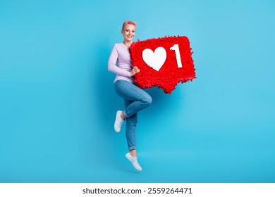 Full body photo of young famous blogging lady purple shirt denim jeans hold huge red pinata like notification isolated on blue background - Powered by Shutterstock