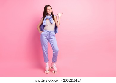 Full body photo of young girl happy smile ride roller skates point thumb empty space ad advice isolated over pastel color background