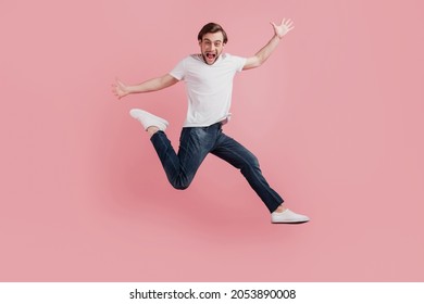 Full Body Photo Of Young Happy Excited Smiling Positive Man Jump Up Active Isolated On Pink Color Background