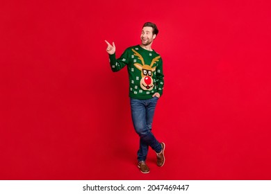 Full body photo of young man happy positive smile indicate finger empty space advert choose isolated over red color background