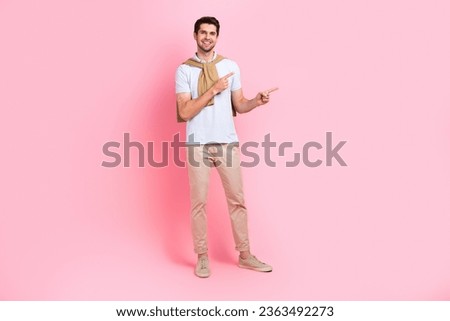 Full body photo of young man professional advertiser white t shirt beige pants pointing fingers novelty isolated on pink color background