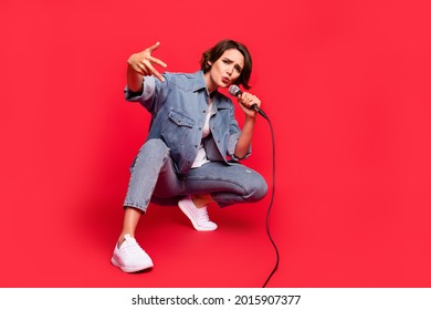 Full body photo of young woman excited cool sing song mic artist concert isolated over red color background