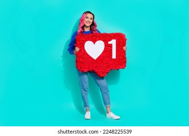 Full body photo of youngster blog girl dyed pink wavy hairdo hold big like symbol subscribe youtube channel isolated on aquamarine color background