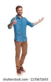 Full Body Picture Of A Casual Man Presenting And Making The Ok Sign On White Background