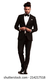 Full Body Picture Of An Elegant Man In Tuxedo Unbuttoning His Coat On White Background