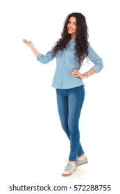 Full Body Picture Of A Smiling Casual Woman Presenting Something On White Background