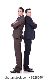 Full Body Picture Of Two Serious Business Men Standing Back To Back Over White Background