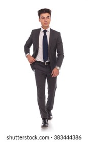 Full Body Picture Of A Young Business Man Walking And Looking Away From The Camera On White Studio Background