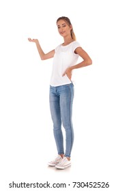 Full Body Picture Of A Young Casual Woman Presenting Something On White Background