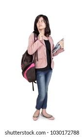 Full body portrait of an Asian female student standing with thoughtful expression, isolated on white background