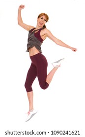 Full Body Portrait Of Attractive Older Woman In Sportswear Jumping Over White Background