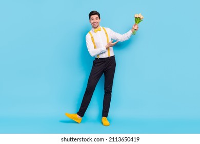 Full Body Portrait Of Attractive Satisfied Man Hold Demonstrate Fresh Flowers Isolated On Blue Color Background