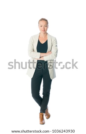 Full body portrait of casualy dressed,cheerful, beautiful, smart, young businesswoman in standing with arms crossed against white background.