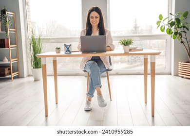 Full body portrait of charming positive lady sitting chair use netbook coworking spacious bright office room inside
