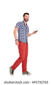 Full Body Portrait Of Cheerful Mature Man Walking With Cell Phone Over White Background