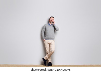 Full Body Portrait Of Cool Businessman Talking On Cellphone