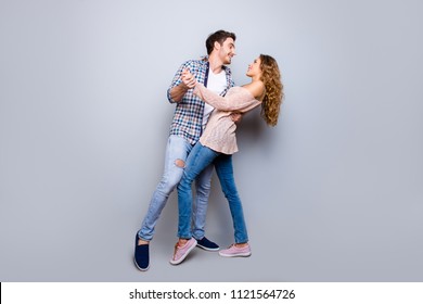 Full Body Portrait Of Creative Cheerful Couple In Casual Outfits Dancing Enjoying Activity Isolated On Grey Background. Move Motion Life Art Concept