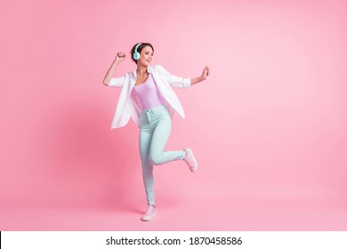 Full body portrait of dancing person make moves earphones unbuttoned shirt isolated on pink color background - Powered by Shutterstock