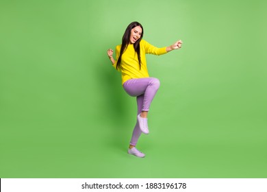 Full body portrait of delighted lady open mouth fists raise knee wear pullover isolated on green color background - Shutterstock ID 1883196178