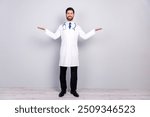 Full body portrait of experienced doctor man hold empty space wear white coat isolated on grey color wall background