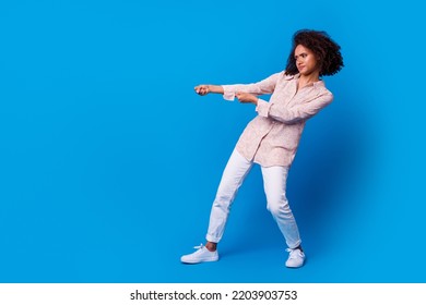 Full body portrait of hardworking determined lady arms pull empty space isolated on blue color background
