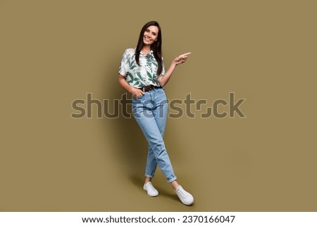 Full body portrait of lovely positive lady indicate finger empty space proposition isolated on brown color background