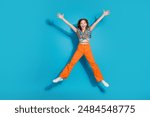 Full body portrait of lovely young girl jump empty space wear top isolated on blue color background