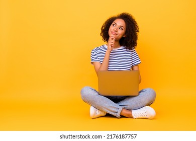 Full body portrait of minded pretty lady arm touch chin look empty space hold netbook isolated on yellow color background - Shutterstock ID 2176187757