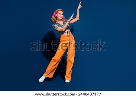 Full body portrait of nice young lady listen music dance empty space wear top isolated on dark blue color background