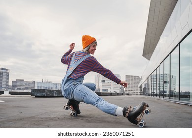 Full body portrait of positive funky woman learning to ride on roller skates