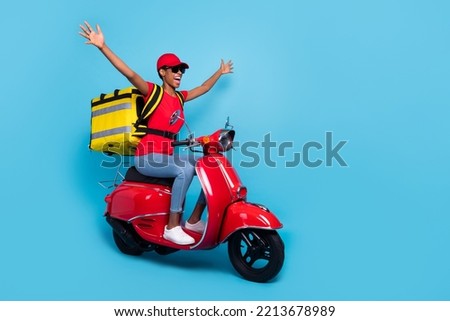 Full body portrait of positive overjoyed person raise hands drive bike isolated on blue color background