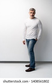 Full Body Portrait Of Relaxed Mature Man Standing Over White Background