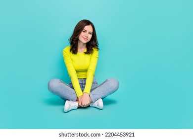 Full Body Portrait Of Satisfied Young Lady Sit Floor Crossed Legs Isolated On Emerald Color Background