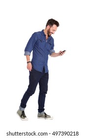 Full Body Portrait Of Smiling Mature Man Walking And Using Mobile Phone Over White Background