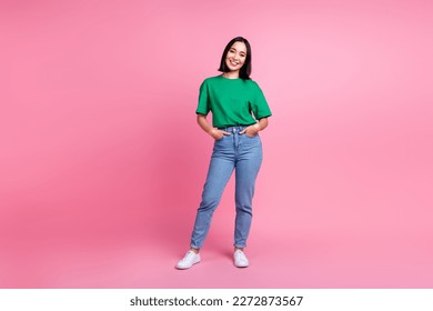 Full body portrait of stunning positive vietnamese lady put hands pockets posing isolated on pink color background