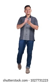 Full Body Portrait Of Young Asian Man Wearing Batik Shirt Standing And Smiling Clapping Hands, Isolated On White