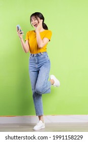 Full body portrait of young asian girl on green background
 - Shutterstock ID 1991158229